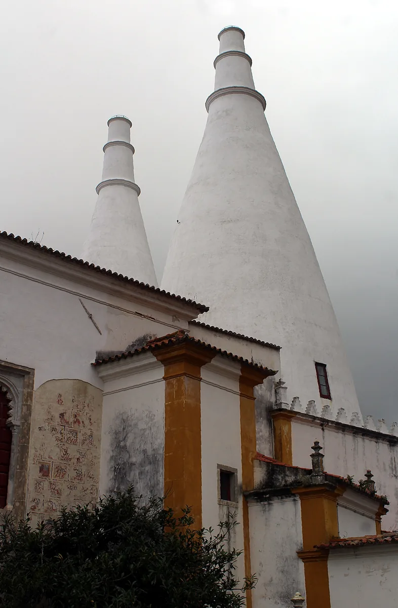 The two white conical chimneys of Sintra National Palace seen from its central courtyard